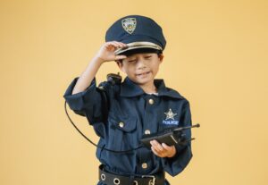 Ethnic kid in police uniform in studio