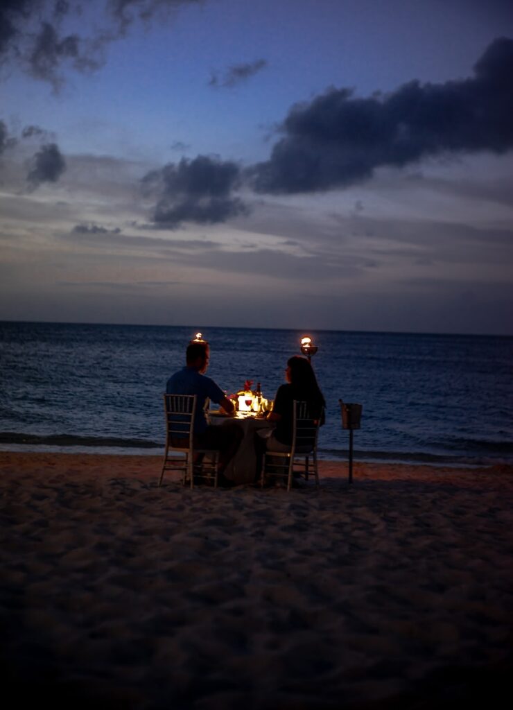 coupe on dinner date on seashore