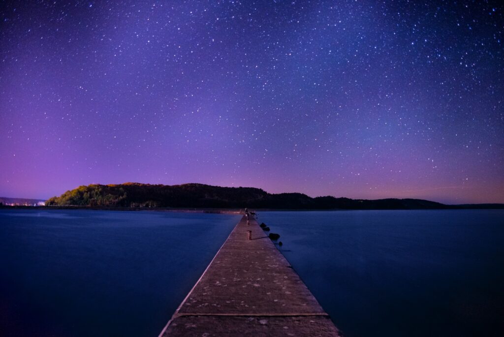 brown wooden dock under night sky